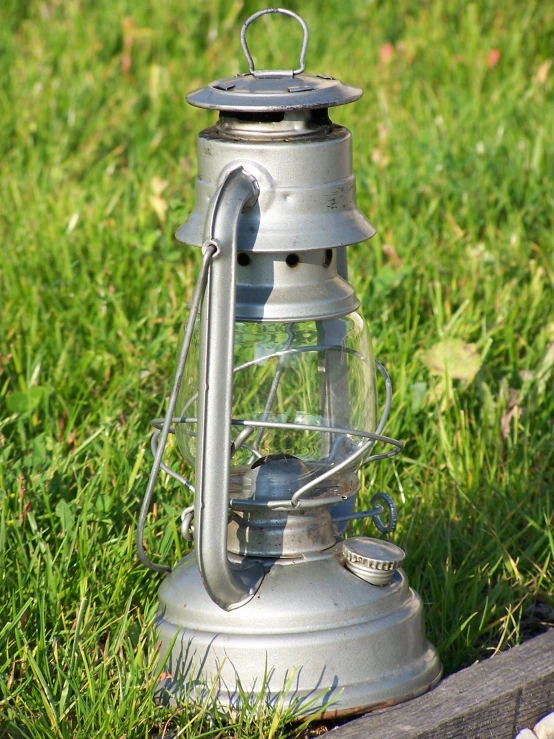 an old keroset light sitting in the grass