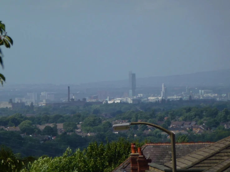 the city is visible from behind the hills