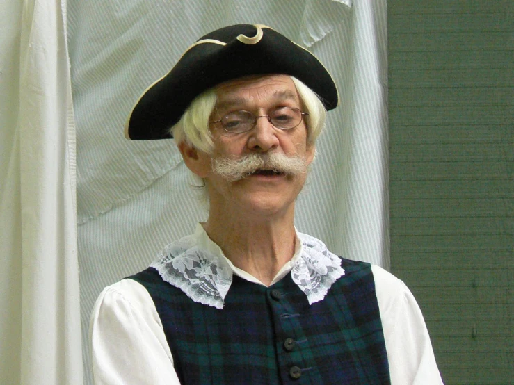 old man wearing pirate hat and white hair