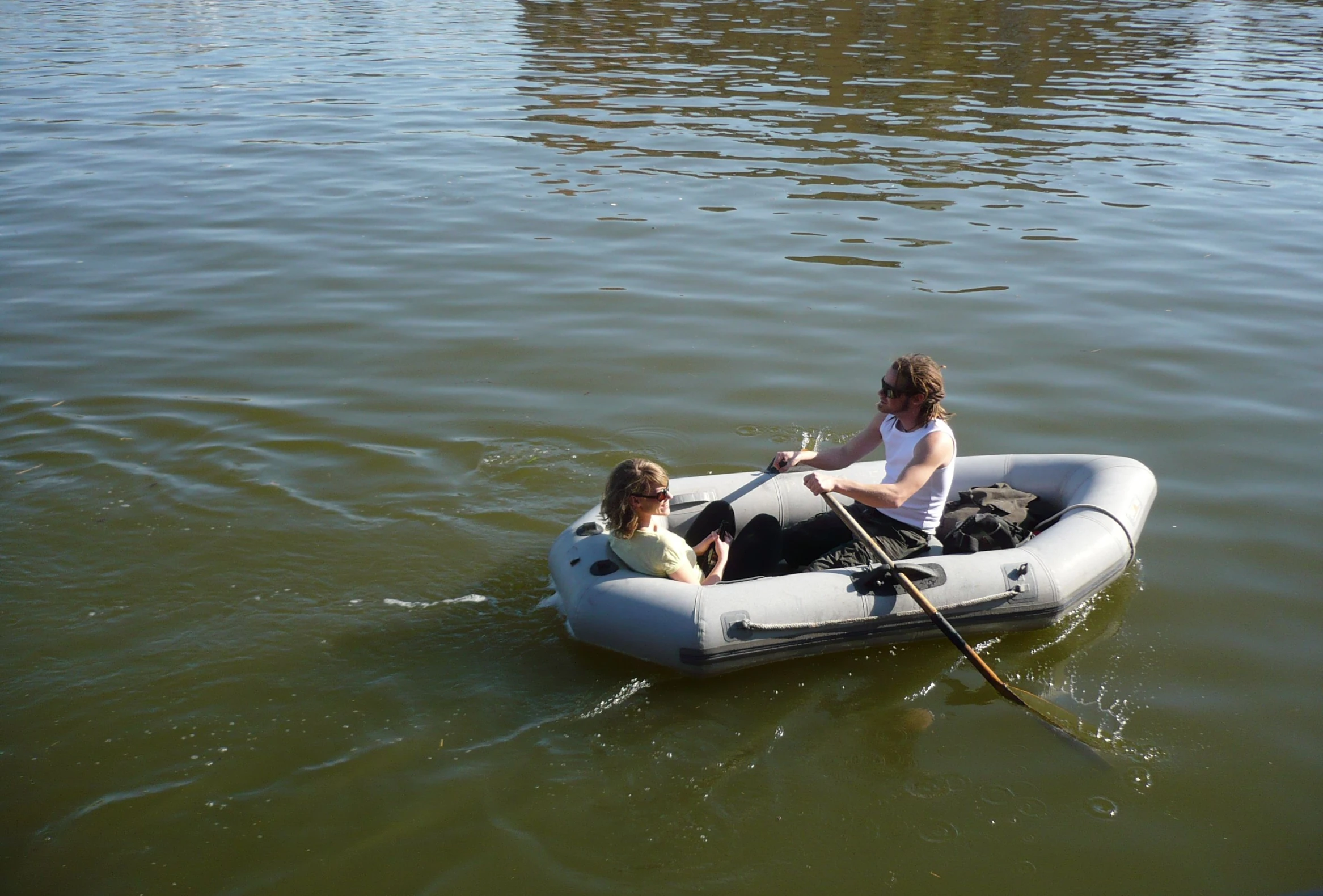 a couple of people riding in an air boat on a body of water