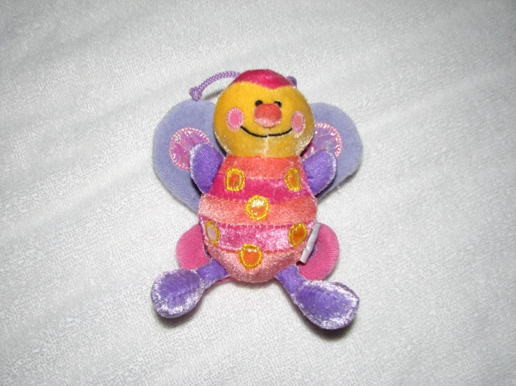 a small purple and yellow stuffed animal