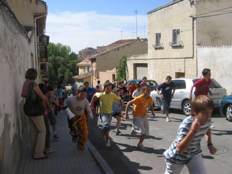 people are walking down the street in a town