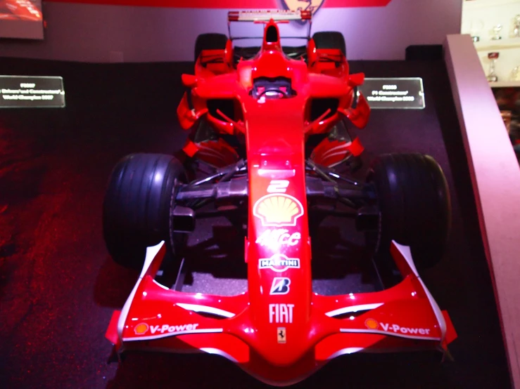 this is a red racing car on display