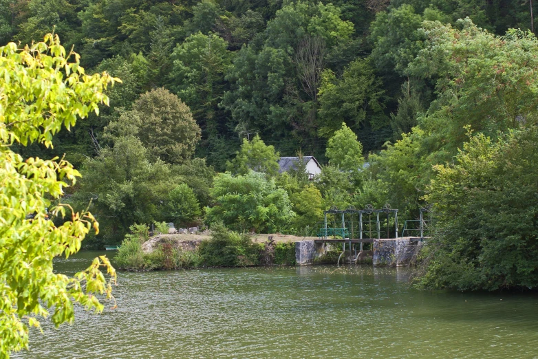 a small wooden structure on the edge of water