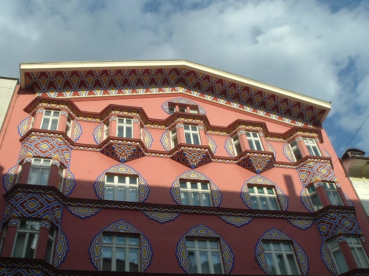 a pink building with a large window on the front