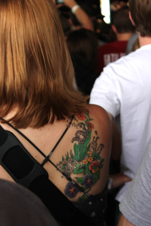 a woman with a floral tattoo on her back