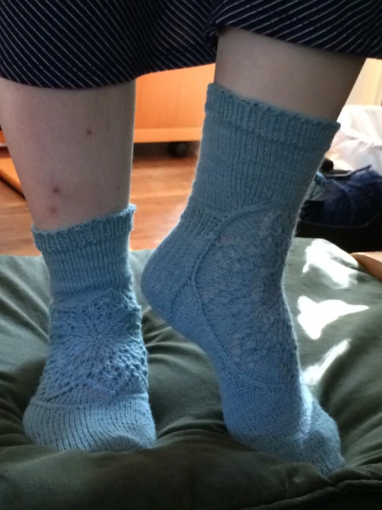 a closeup of the bottom of a persons legs in socks