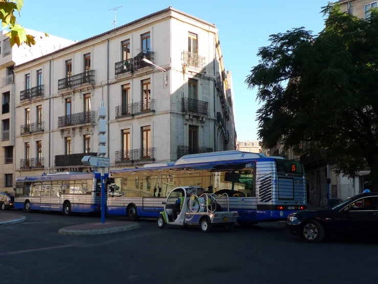 an outdoor space with multiple large busses parked on the street