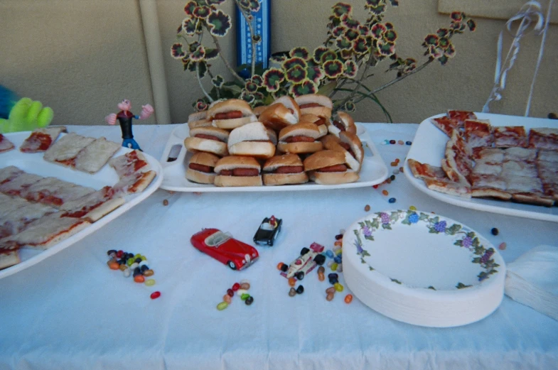 a table filled with lots of food on trays