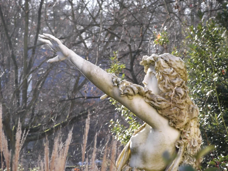 a large statue of a woman reaching for an object