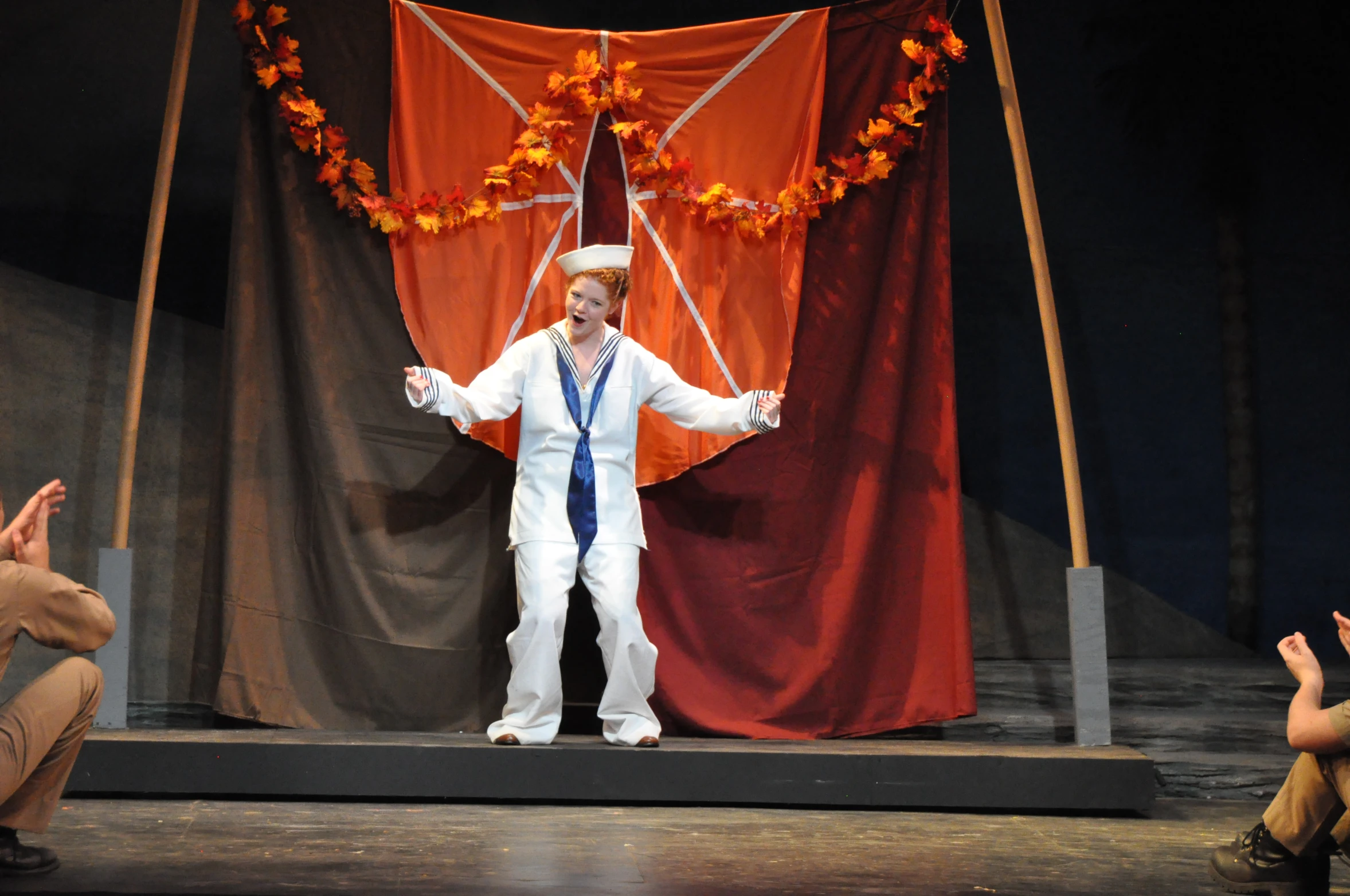 a man in white on stage performing a show