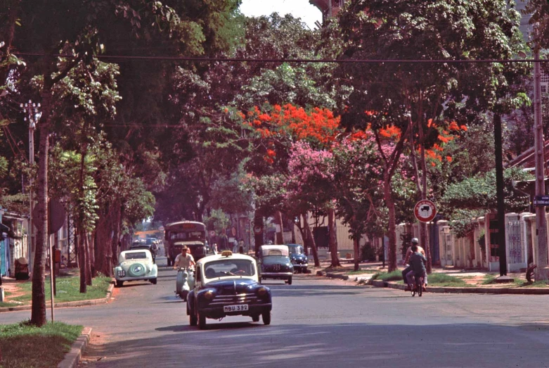 a street is lined with vintage cars and old - fashioned vehicles