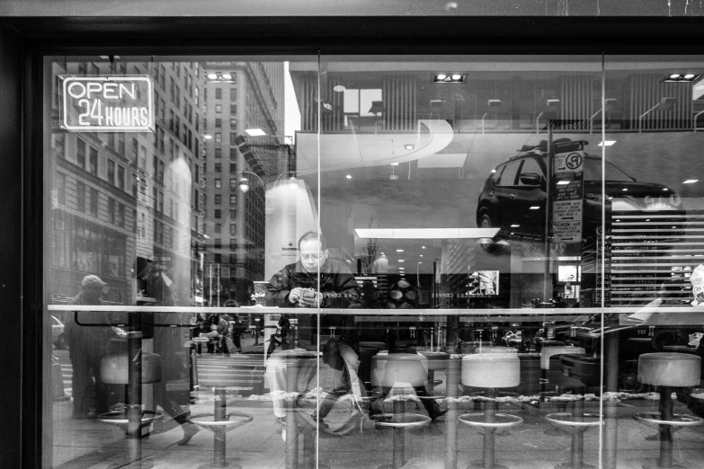 people are sitting at a table in front of a building