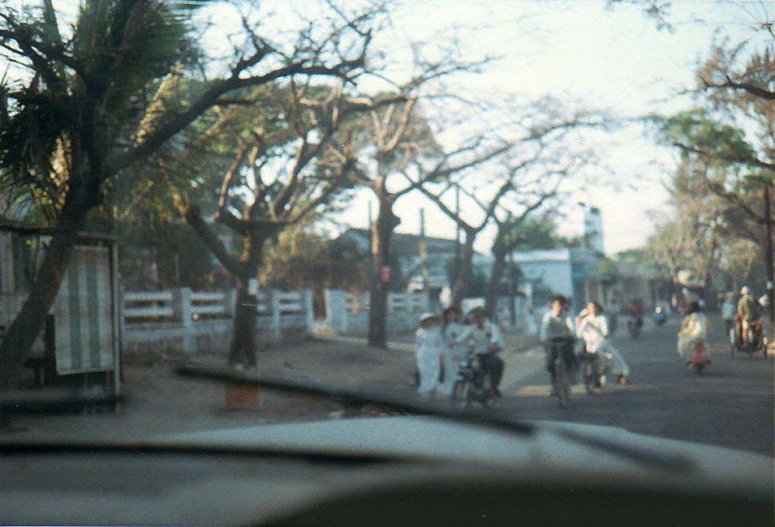 a street scene with a line of parked cars