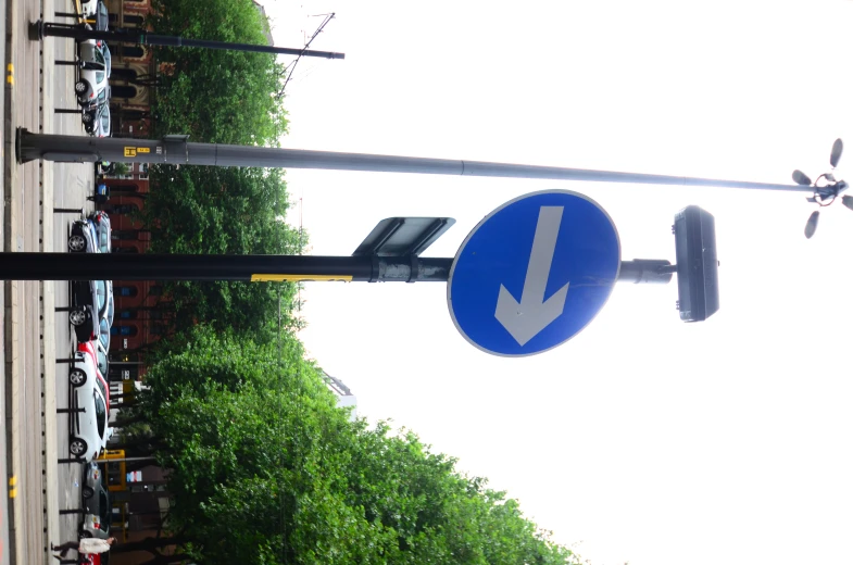 a street sign that is next to a pole with a arrow