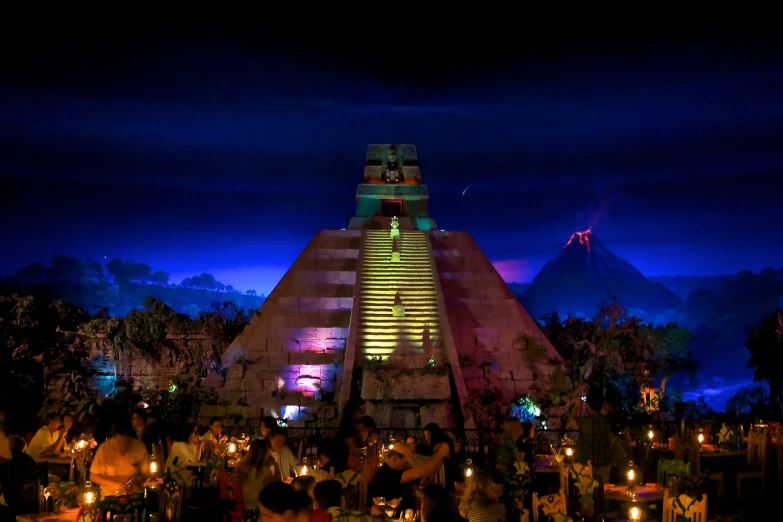 people standing near an unusual building at night