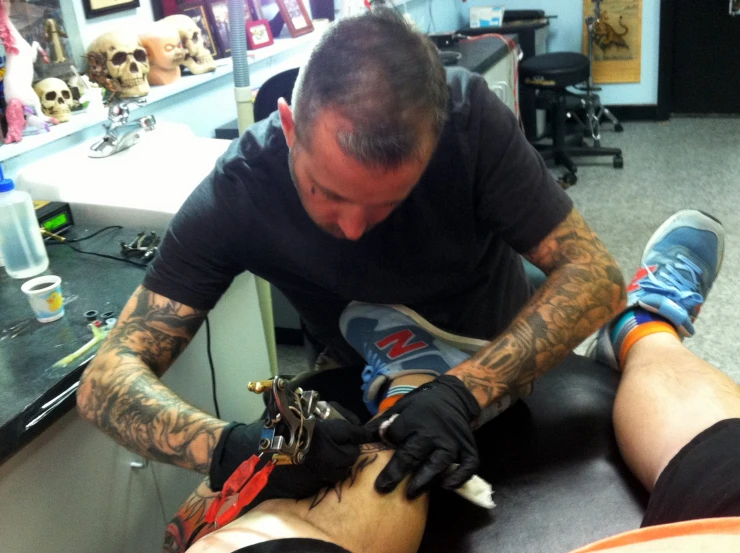 a man getting a tattoo at his office