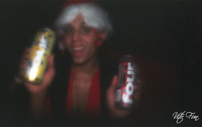 a young person in a santa hat drinking a coca cola