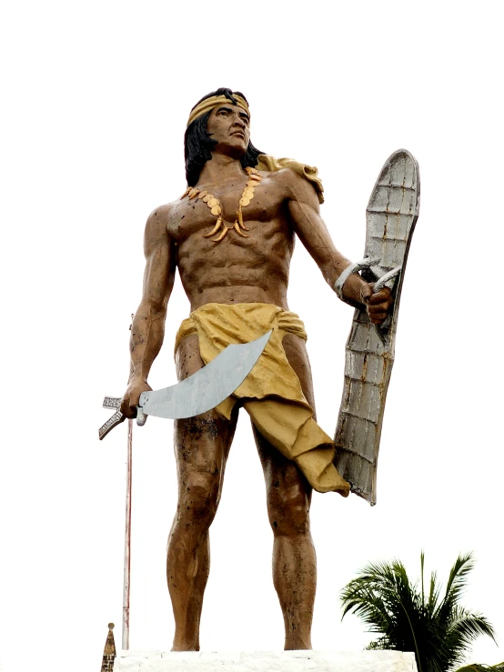 statue of a man with a surfboard on top of a building