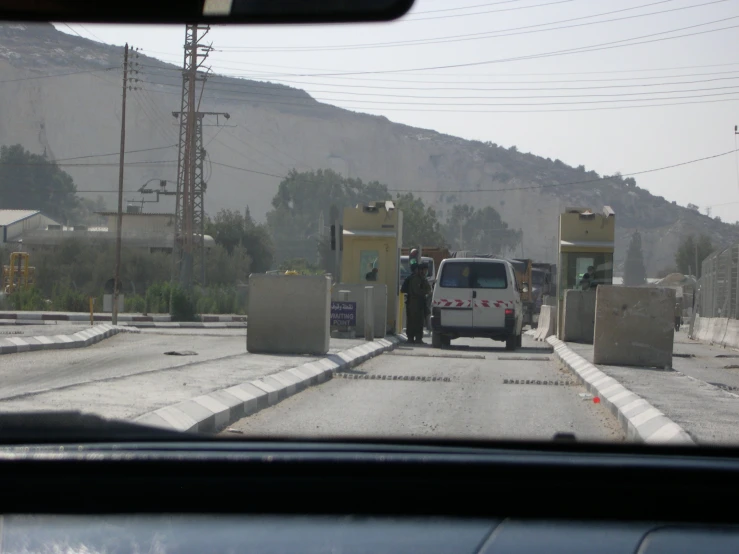 a car waiting at a closed gate to enter a house