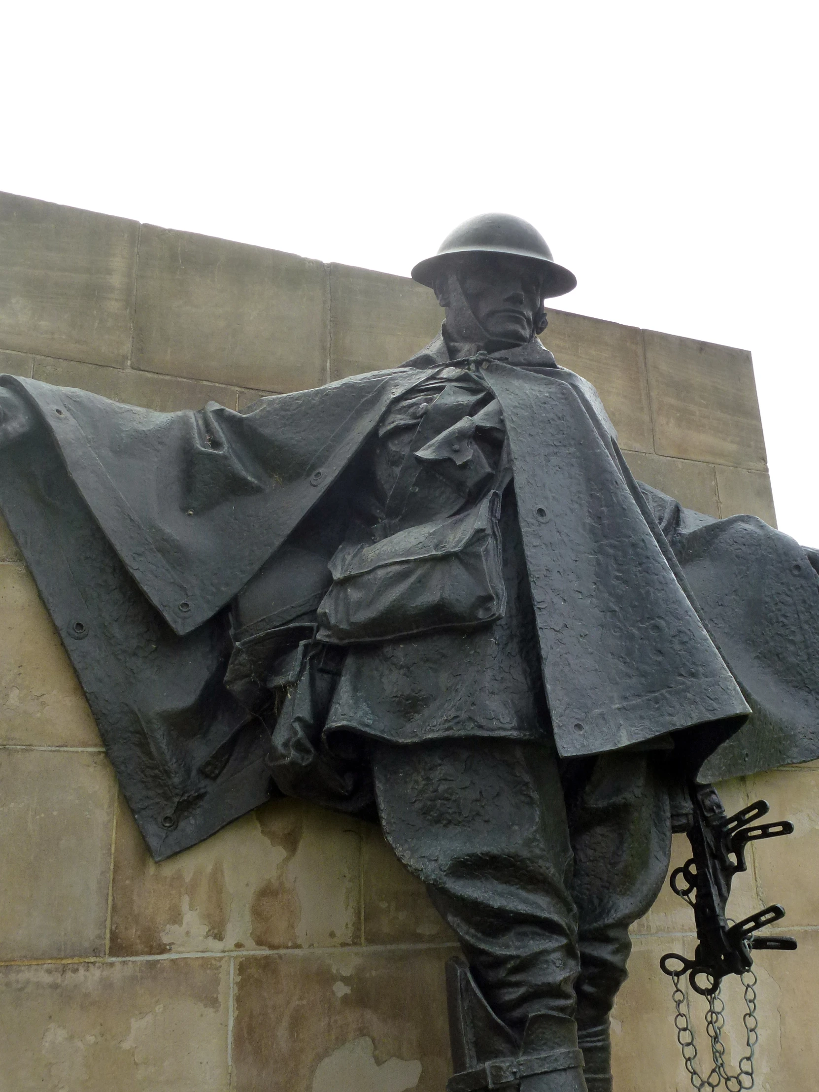 a statue is standing next to a wall