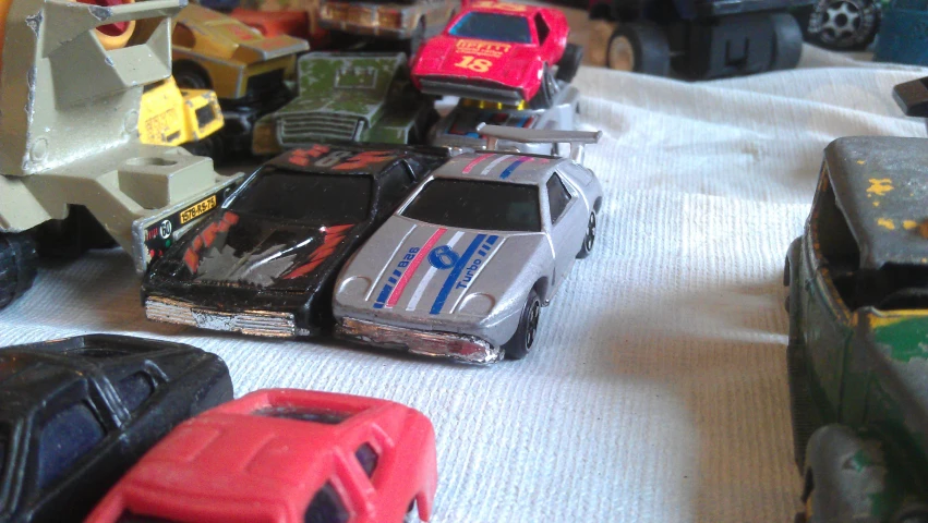 an assortment of toy cars in small batch on a table