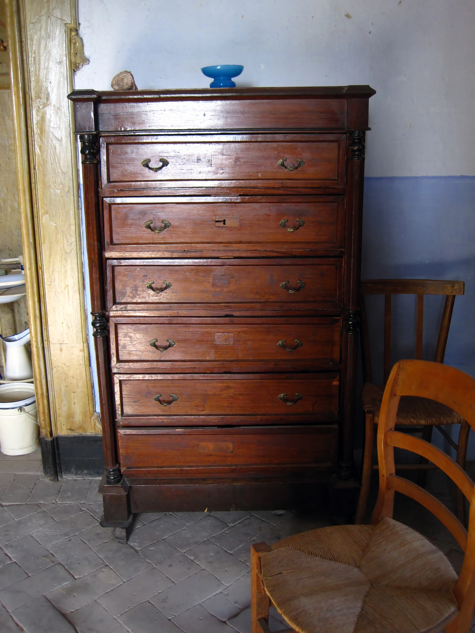 an old dresser with several drawers in it