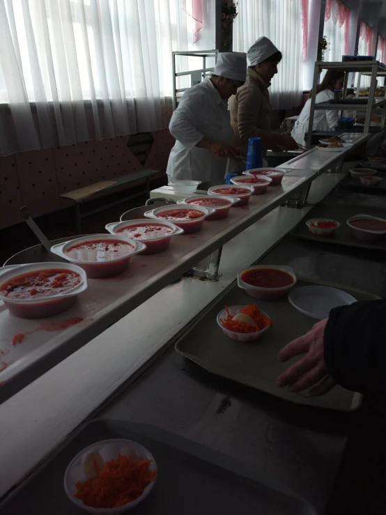 people preparing food in a kitchen at a restaurant