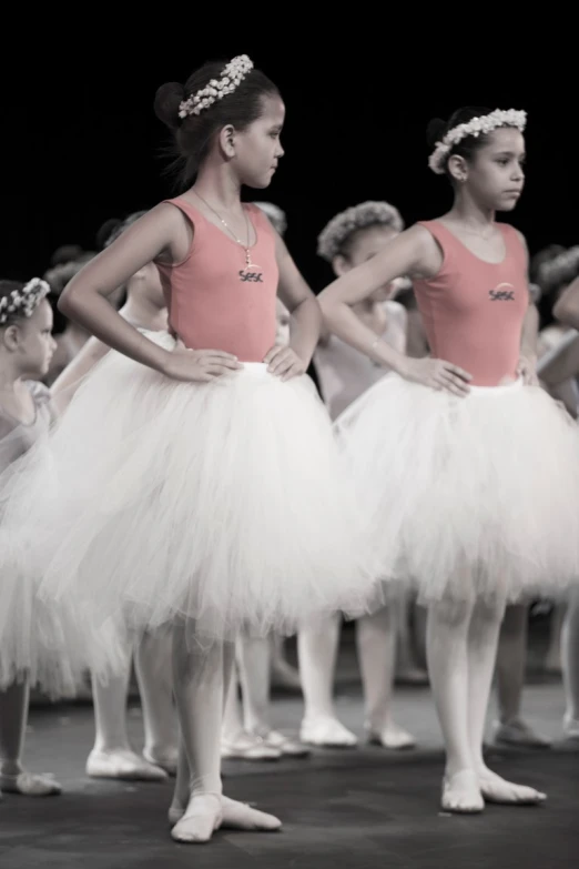 three girls dressed in pink and white tutus