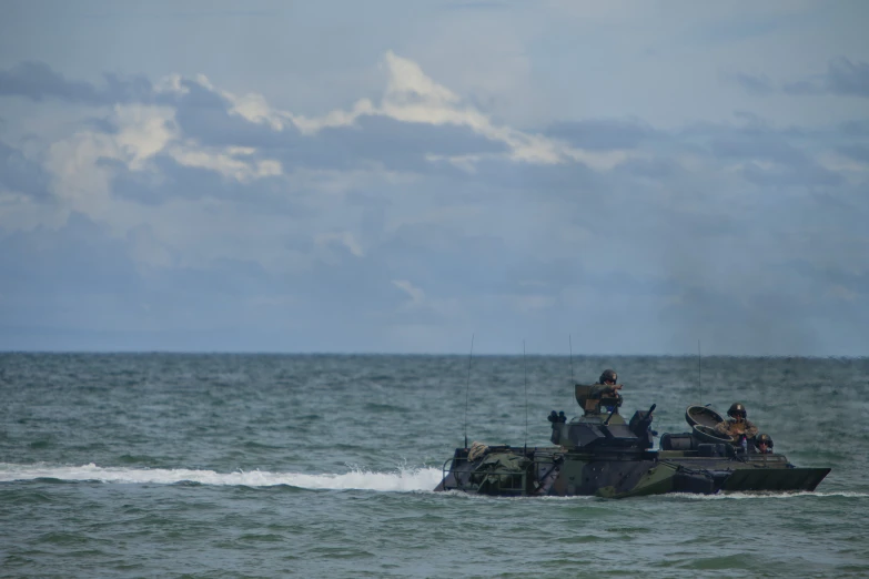 two boats with people on top traveling in the ocean