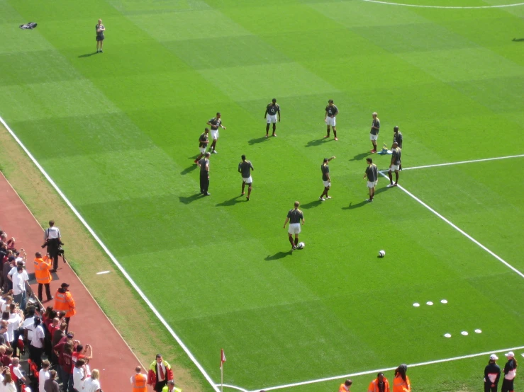 a group of soccer players warming up on a field