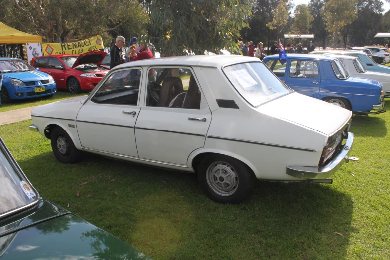 old cars parked in the grass on display