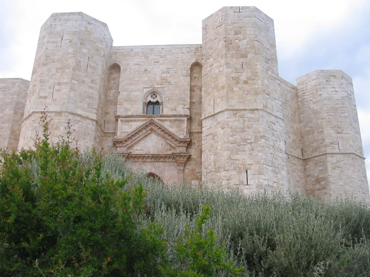 a stone building that has a bell on it