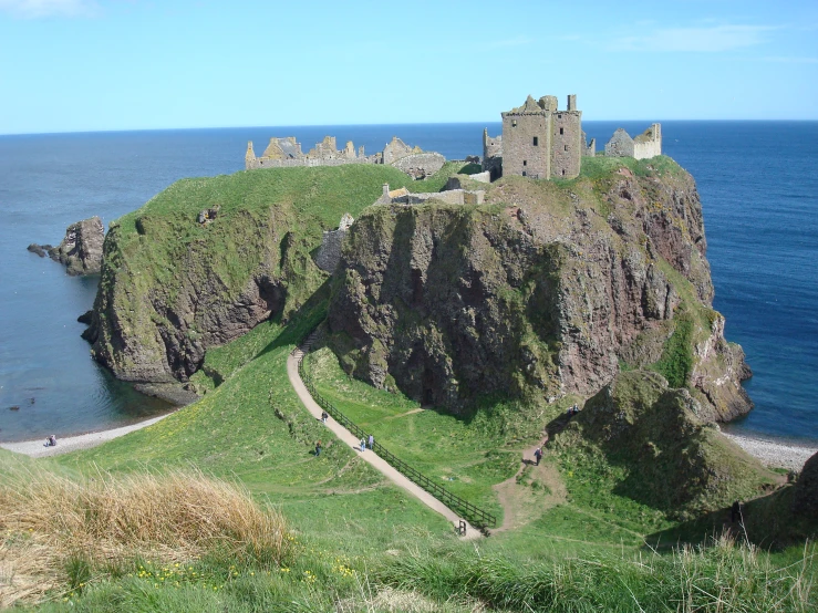 a very old stone castle with a path going through it