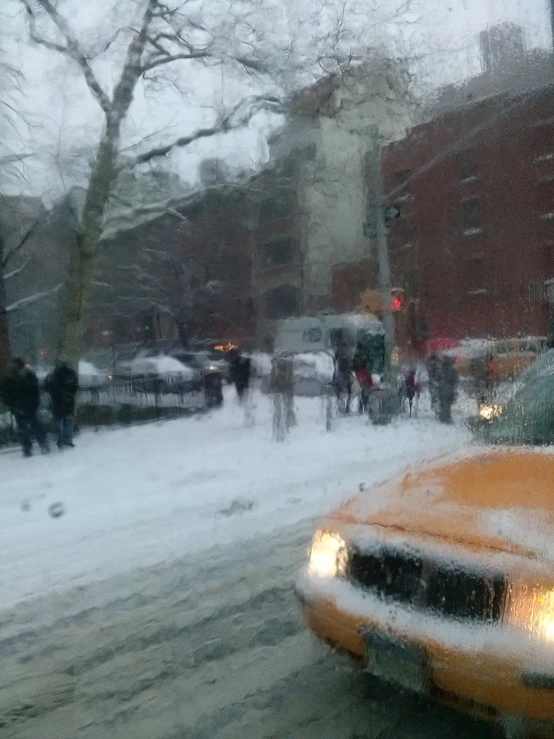 a car in the snow that is driving down a street