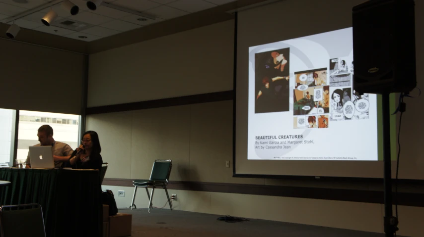 two people sitting down talking and having a presentation