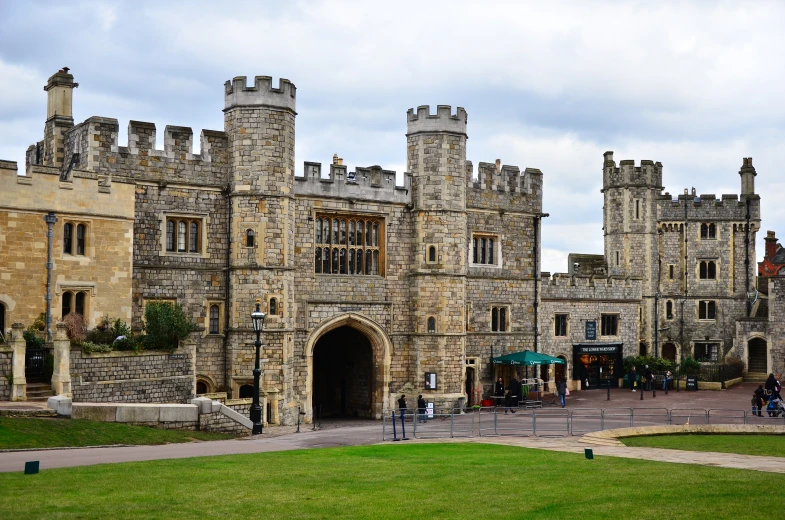 there is an old castle that has people out front