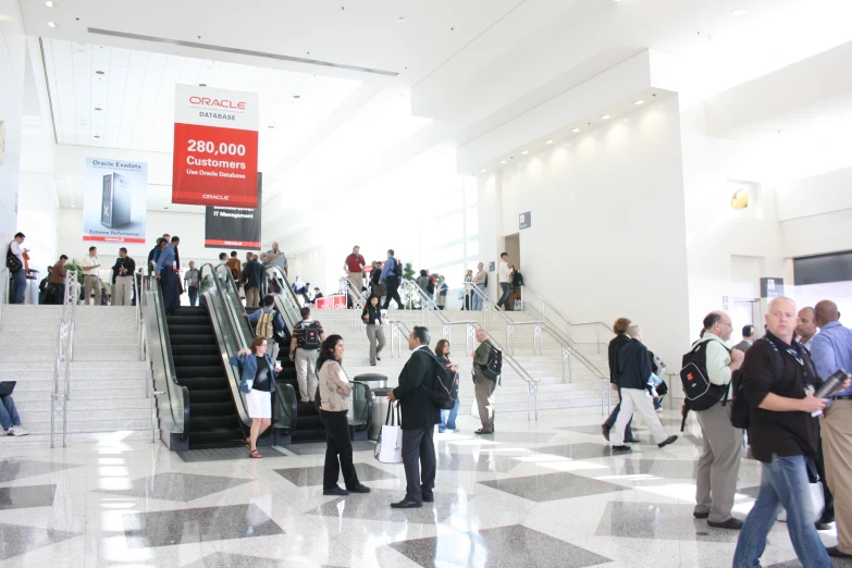 large group of people going up and down stairs in a building