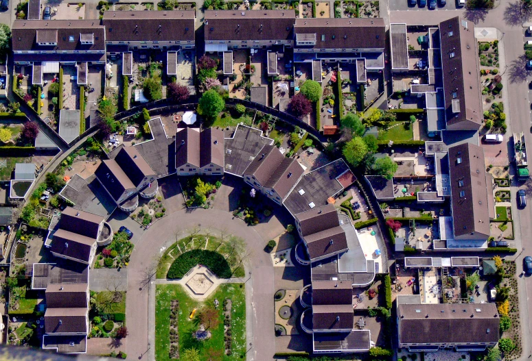 an aerial view of a suburban area with a large circular roof