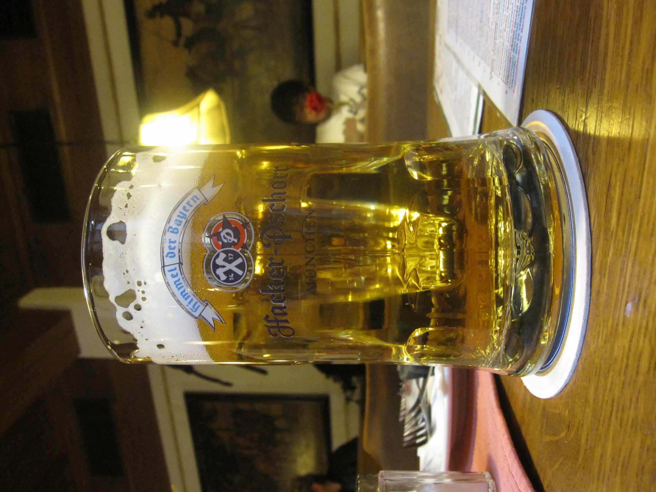 glass sitting on a table with a beverage next to it