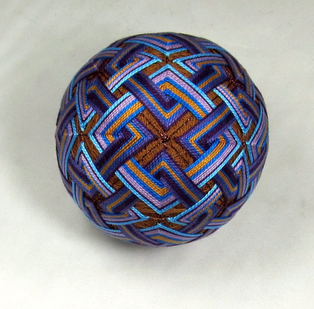 a small ball made up of yarn with blue and red lines