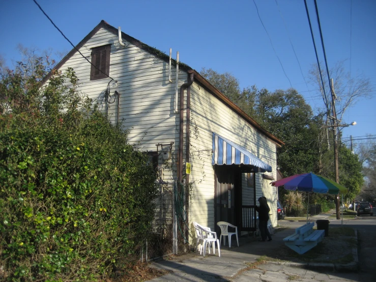 an old white barn with some blue windows