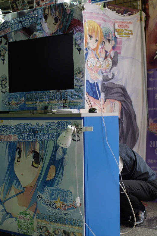 a woman kneeling next to an electronic computer