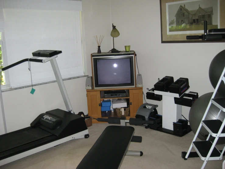 small home gym room with exercise equipment and old tv