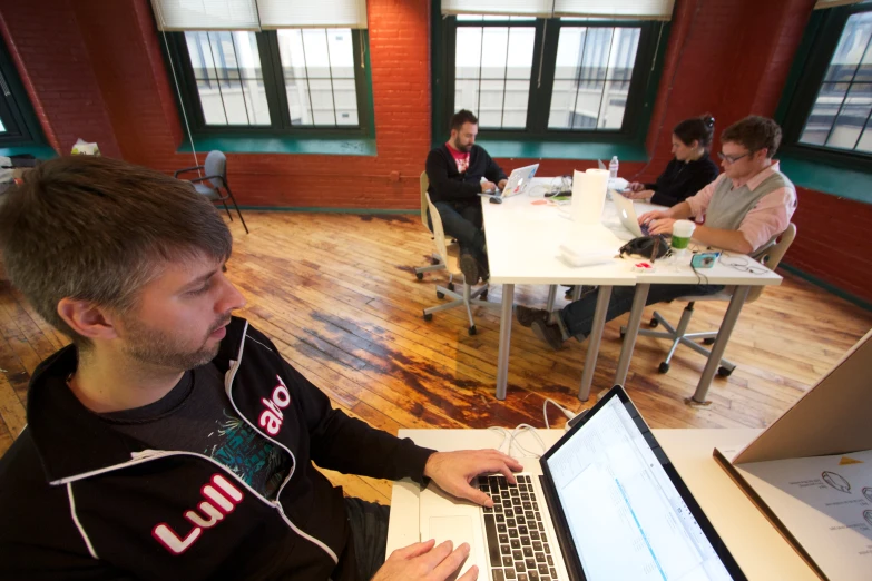 man with a headphones on his ears looking at his laptop