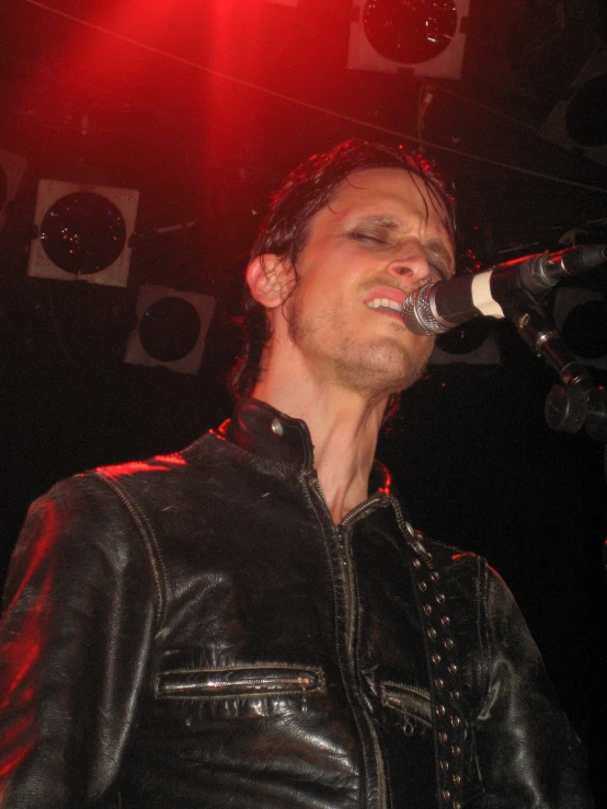 a man that is standing up in the air with a microphone