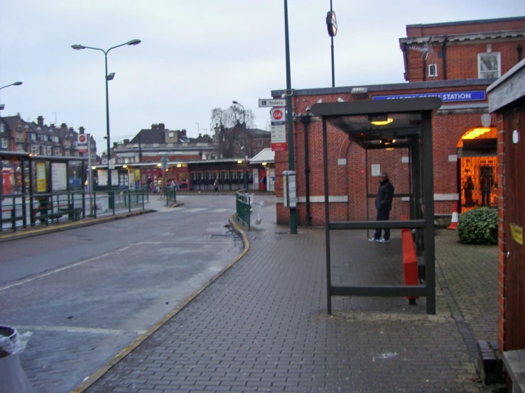 a bus stop sitting on the side of a road