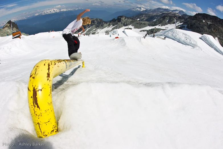 a person is standing on a snowboard in the snow