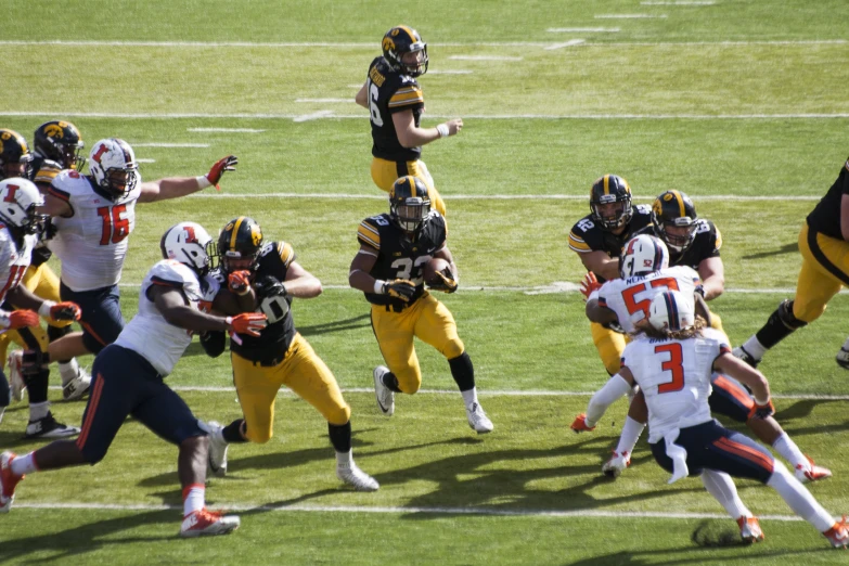 a football team running after a player on the field