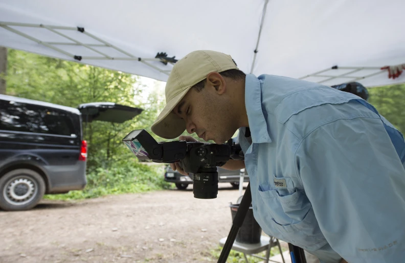 a man taking pos with his digital camera